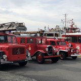 Old fire engines exhibited in the harbor of Bergen