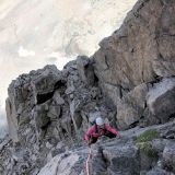 Barbara climbs focused in a less steep, more brittle section